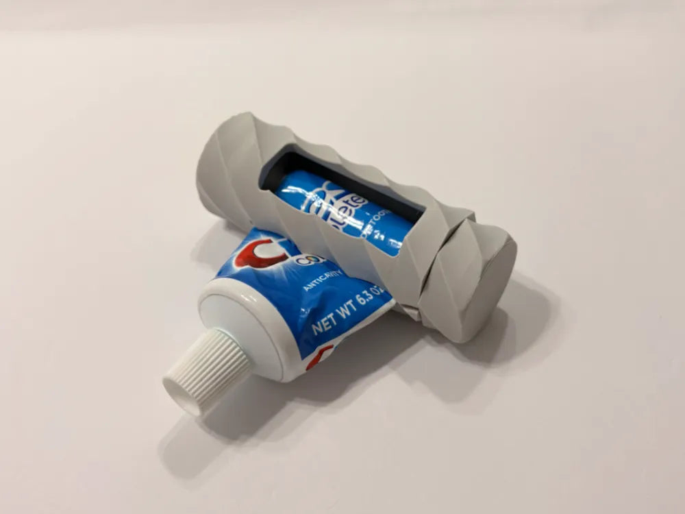 Exprimidor de pasta dental 3D gris con tubo Colgate