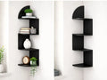 Estante esquinero 3D negro en zigzag de 4 niveles instalado en esquina de pared con objetos decorativos